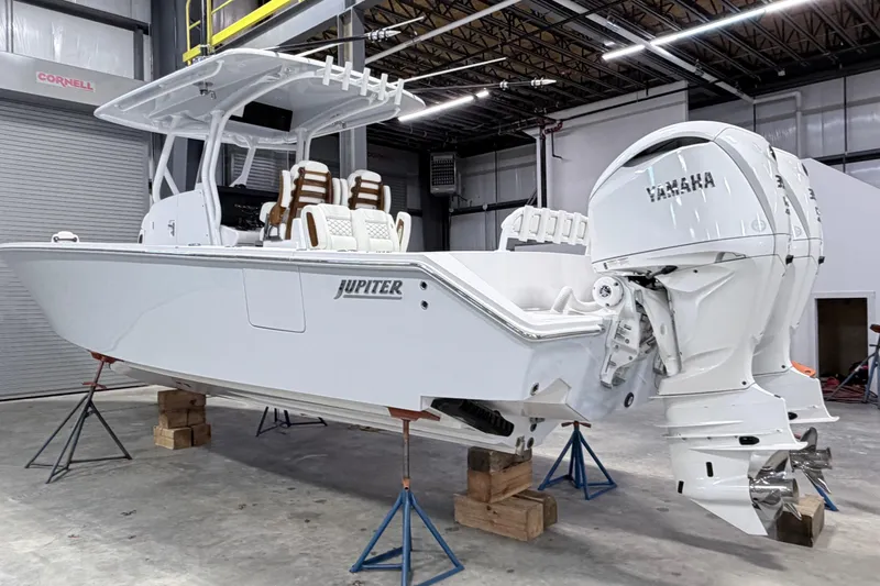 Slide: The Image of 2026 Jupiter 32 boat in a workshop, featuring dual Yamaha engines. - 20