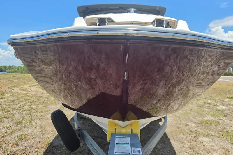 Slide: The Image of 2022 Yamaha Boats 252SD on trailer, viewed from the front, outdoors. - 12