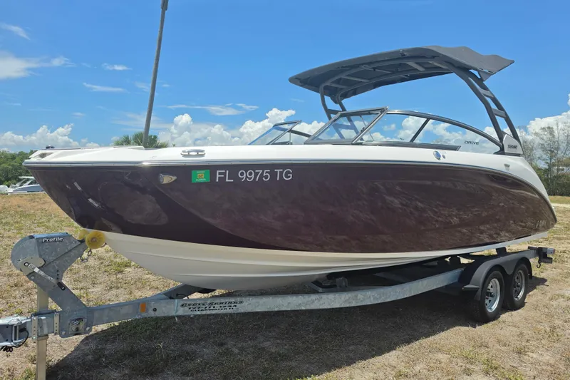 Slide: The Image of 2022 Yamaha Boats 252SD on trailer, parked outdoors under a clear blue sky. - 9