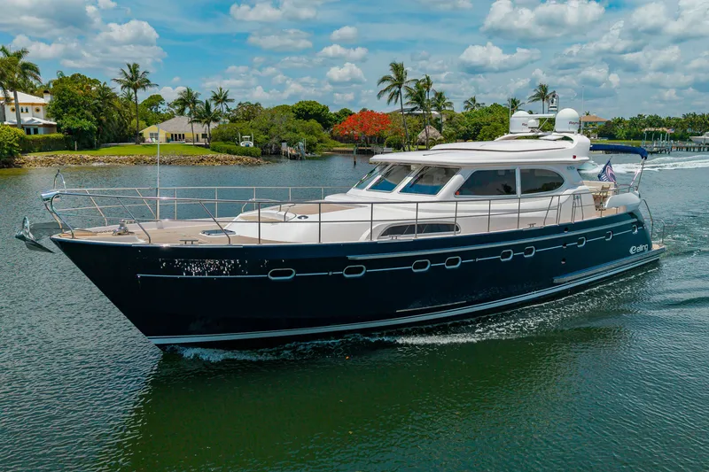 Slide: The Image of A luxurious motor yacht cruises on a calm river, surrounded by palm trees and houses. - 4
