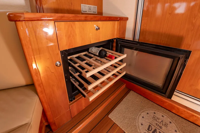 Slide: The Image of A sleek wine cabinet with wooden racks and a glass door in a luxurious boat. - 24