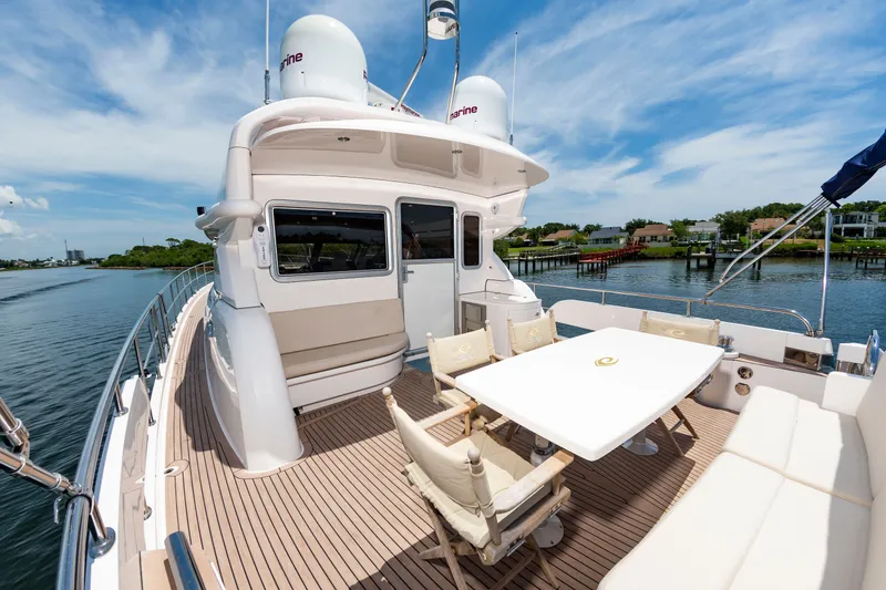 Slide: The Image of The image shows the deck of a 2020 Elling E6 yacht with a table and chairs. - 12
