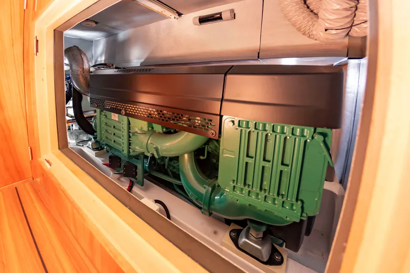 Slide: The Image of A modern engine in a well-lit engine room with wooden paneling. - 36