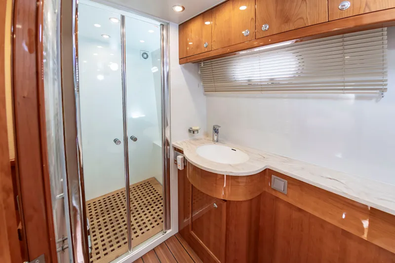 Slide: The Image of The bathroom of a 2020 Elling E6 yacht with wooden cabinets and a shower. - 44