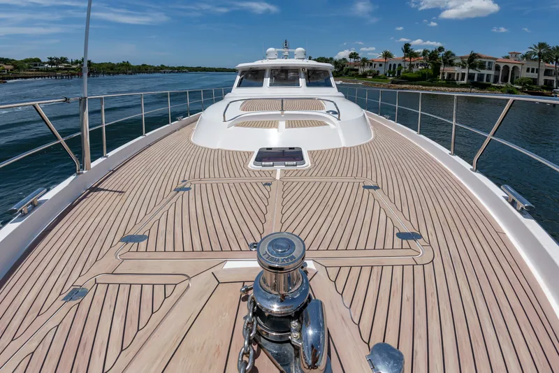 Slide: The Image of The image shows the foredeck of a 2020 Elling E6 yacht on calm waters. - 7