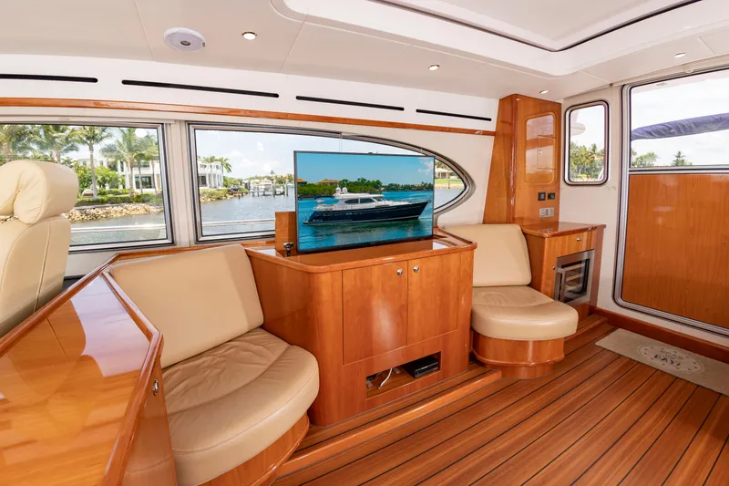 Slide: The Image of Interior of a luxury yacht with wooden floors, comfortable seating, and a large TV. - 19
