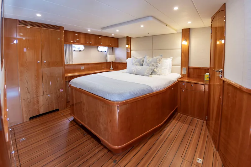 Slide: The Image of Luxurious cabin with wooden floors and a large bed, surrounded by elegant wood paneling. - 40