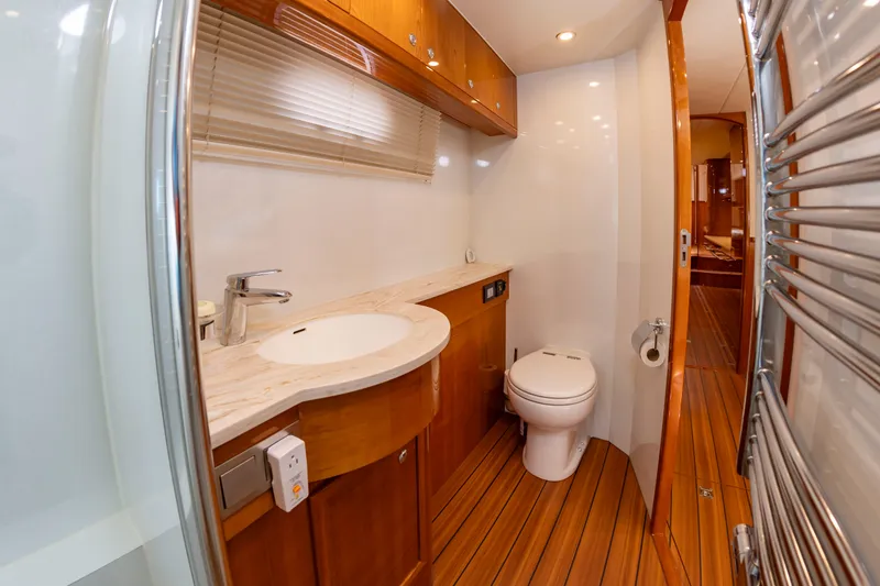 Slide: The Image of Bathroom on a 2020 Elling E6 yacht with wood paneling and modern fixtures. - 46
