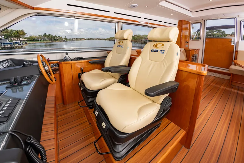 Slide: The Image of Interior of a luxury yacht with two beige leather seats and wooden flooring. - 23