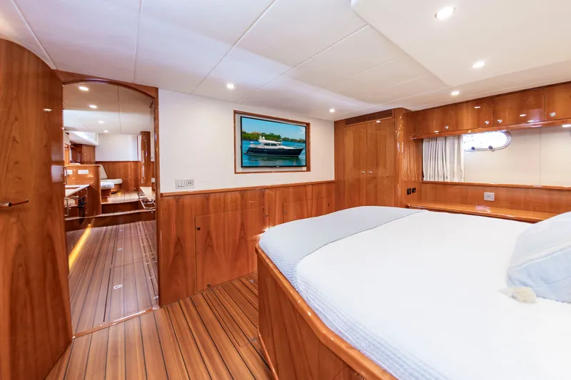 Slide: The Image of Luxurious cabin with wooden floors and a large bed, surrounded by elegant wooden walls. - 42