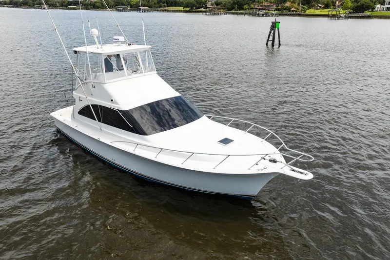 The Image of 2000 Ocean Yachts 43 Super Sport boat on calm water, showcasing sleek design. - 1