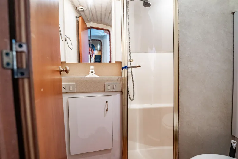 Slide: The Image of Bathroom interior of 2000 Ocean Yachts 43 Super Sport, featuring shower and vanity. - 27