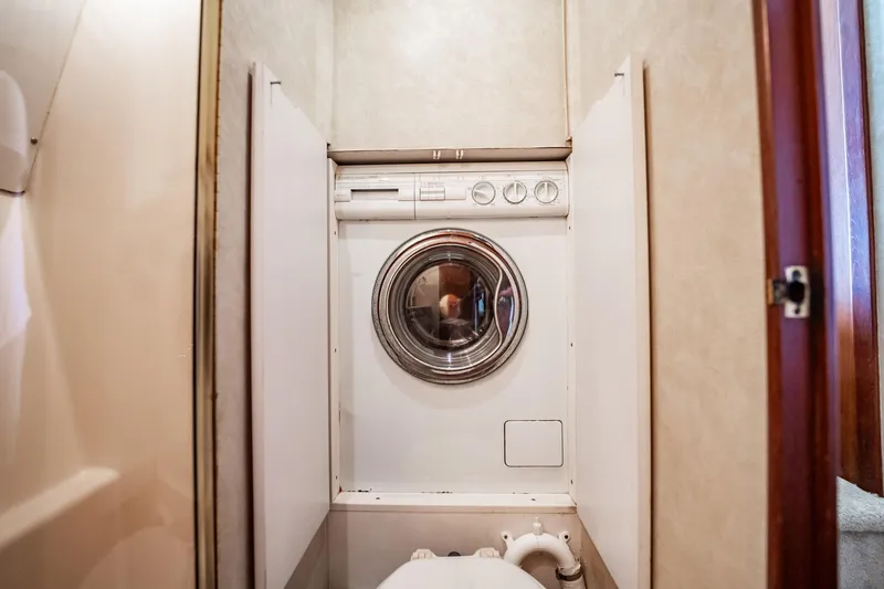 Slide: The Image of Laundry area with washing machine inside 2000 Ocean Yachts 43 Super Sport. - 28