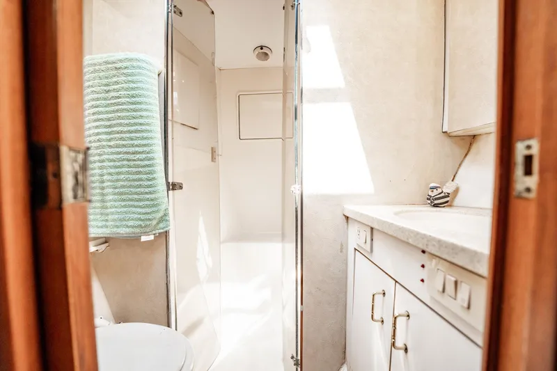 Slide: The Image of Bathroom interior of 2000 Ocean Yachts 43 Super Sport, featuring shower and vanity. - 29