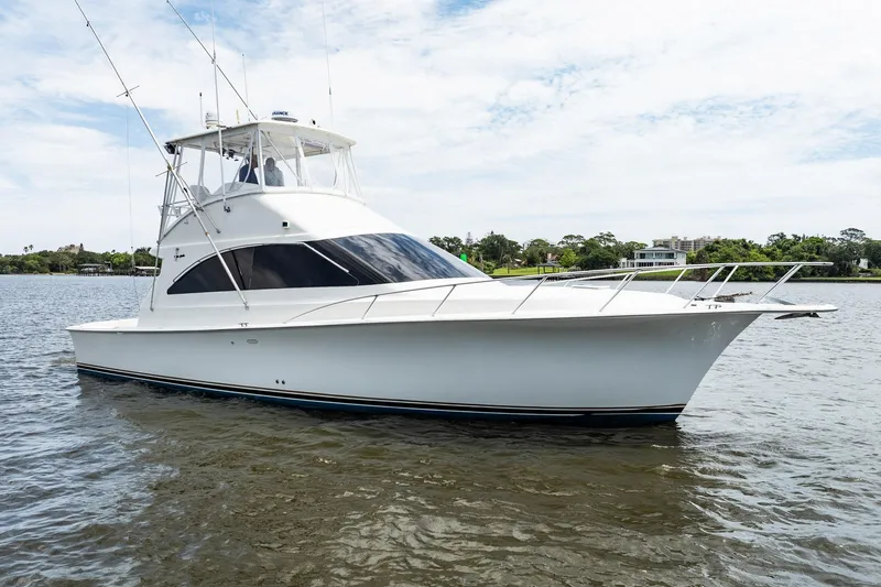 Slide: The Image of 2000 Ocean Yachts 43 Super Sport boat on calm water, showcasing sleek design and fishing equipment. - 39