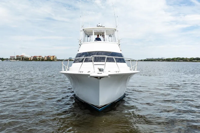 Slide: The Image of 2000 Ocean Yachts 43 Super Sport cruising on calm waters under a cloudy sky. - 40
