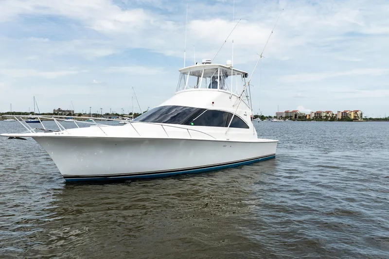 Slide: The Image of 2000 Ocean Yachts 43 Super Sport cruising on calm waters under a clear sky. - 41