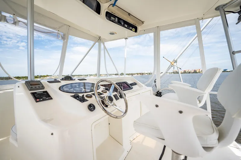 Slide: The Image of Helm of 2000 Ocean Yachts 43 Super Sport with steering wheel and navigation equipment. - 5