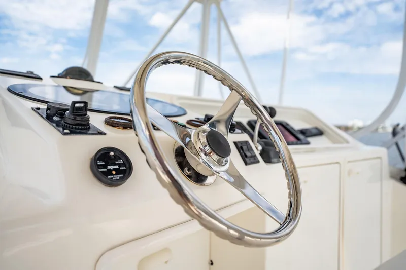 Slide: The Image of Steering wheel of 2000 Ocean Yachts 43 Super Sport, showcasing sleek design and controls. - 7