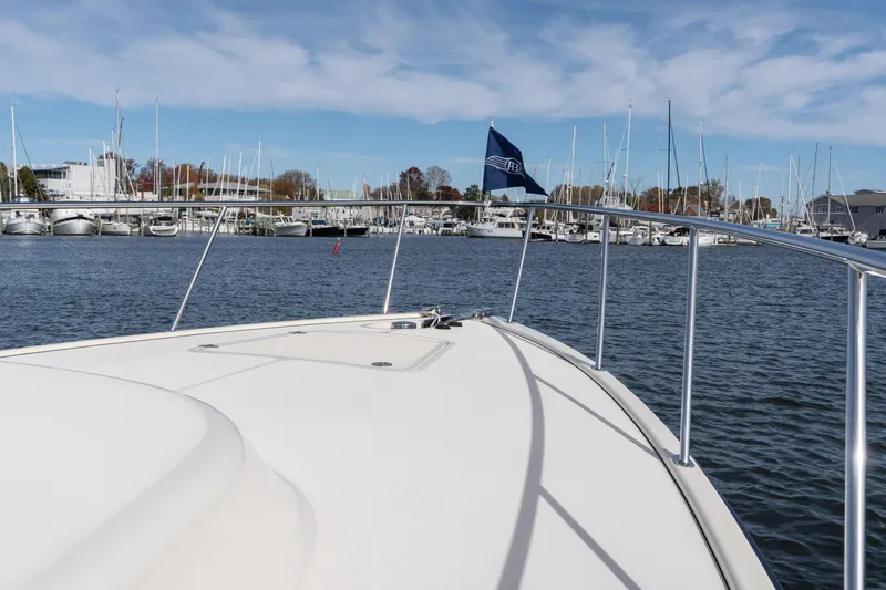 Slide: The Image of 2016 Palm Beach Motor Yachts PB50 on water, marina in background, clear sky. - 27