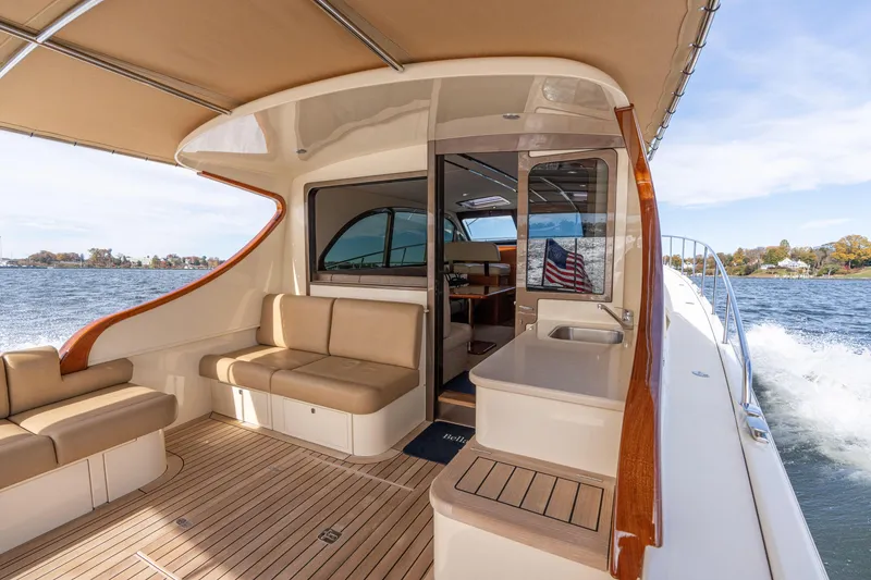 Slide: The Image of Luxurious 2016 Palm Beach Motor Yachts PB50 interior with elegant seating and scenic water view. - 56