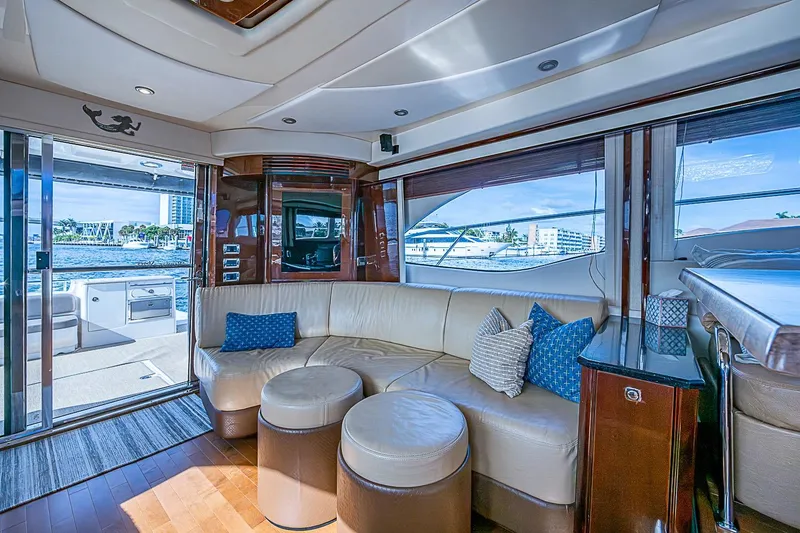 Slide: The Image of Luxurious interior of 2010 Sea Ray 520 Sedan Bridge yacht with leather seating and waterfront view. - 39