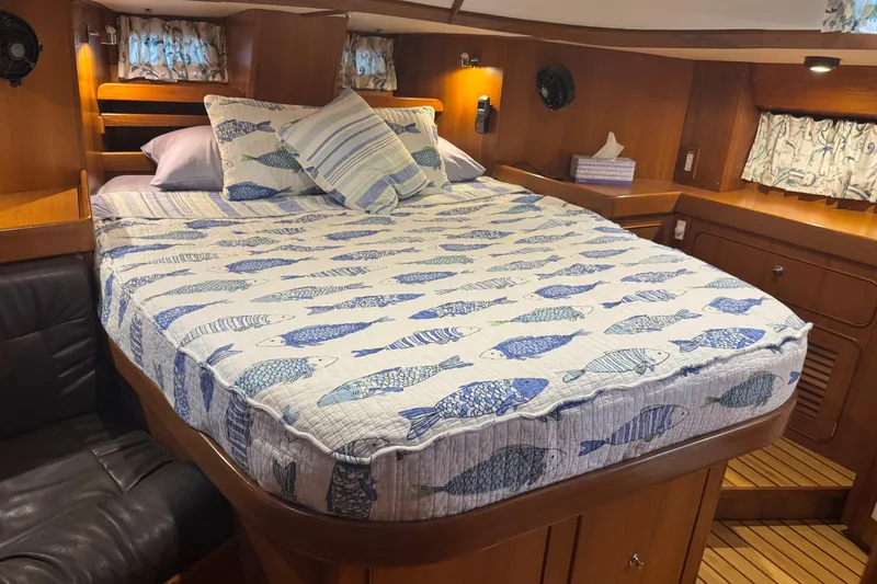 Slide: The Image of Cozy cabin interior of 2007 Hylas H49 yacht with fish-patterned bedding. - 2