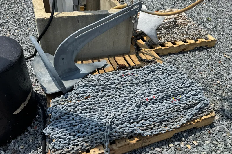 Slide: The Image of Anchor and chain on wooden pallets, Hylas H49 2007 model, resting on gravel surface. - 77