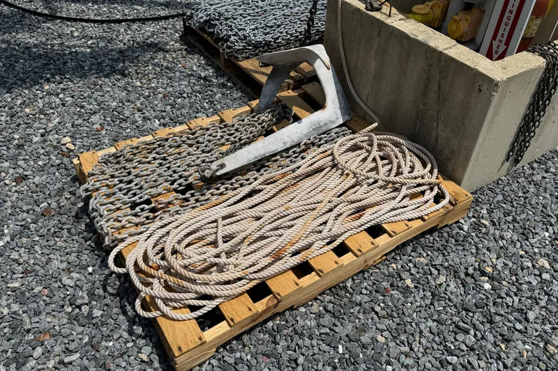 Slide: The Image of Anchor, chains, and rope on wooden pallet, gravel background, Hylas H49 2007. - 76