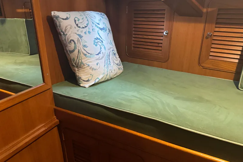 Slide: The Image of Cozy cabin interior of 2007 Hylas H49 yacht with green cushion and decorative pillow. - 8