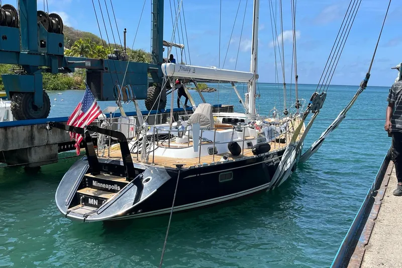 Slide: The Image of Sailing yacht Hylas H49 (2007) docked, displaying American flag, clear blue water background. - 78