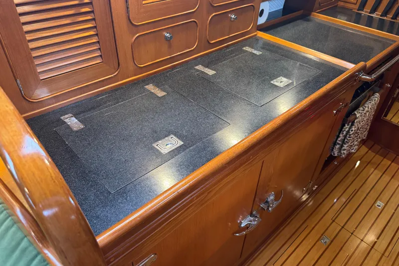 Slide: The Image of Luxurious wooden interior of a 2007 Hylas H49 yacht galley with sleek countertops. - 32