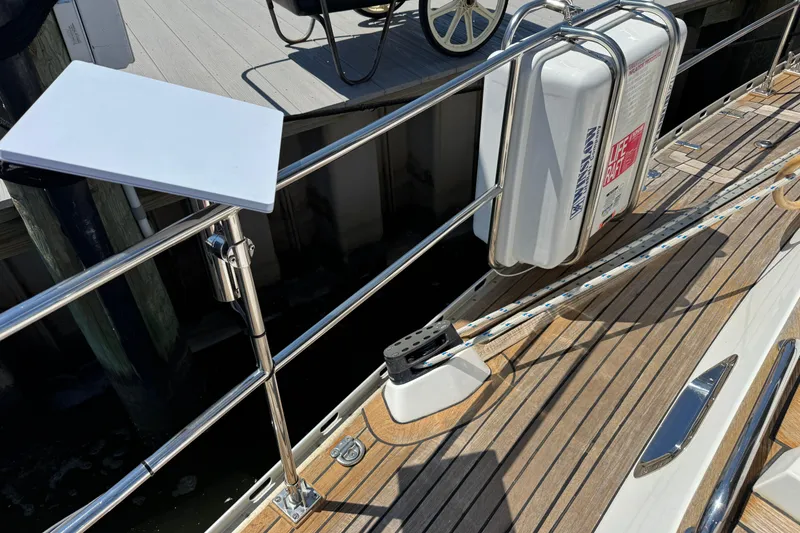 Slide: The Image of Deck of 2007 Hylas H49 yacht with safety equipment and wooden flooring. - 63