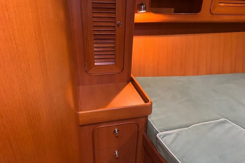 Slide: The Image of Interior of 2007 Hylas H49 yacht featuring wooden cabinetry and cushioned seating area. - 7