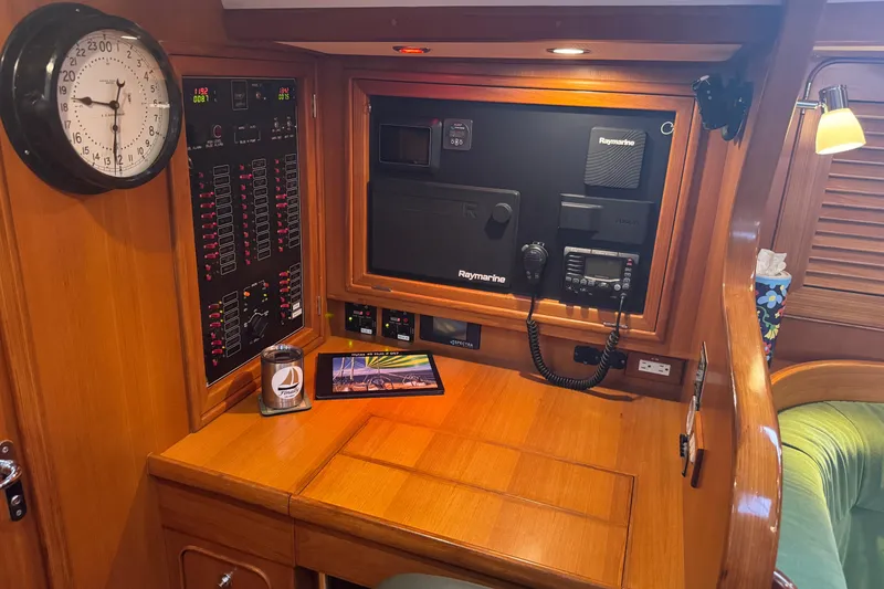 Slide: The Image of Navigation station of a 2007 Hylas H49 yacht with control panels and clock. - 22