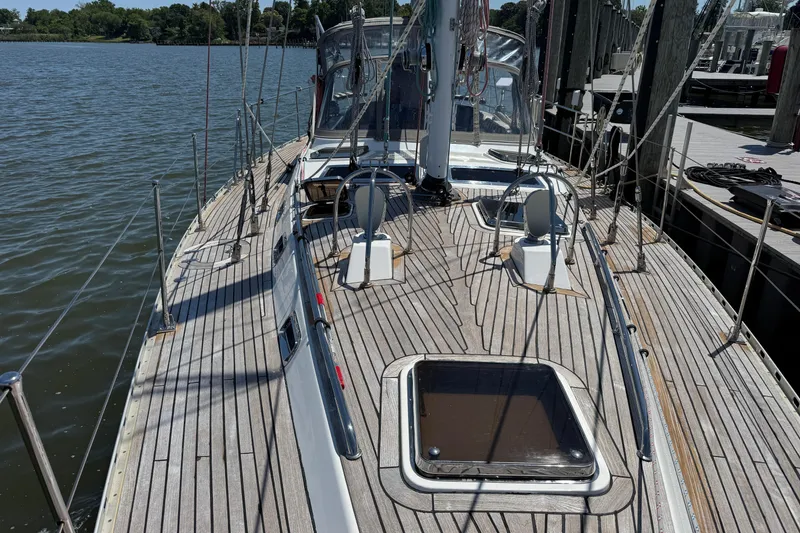 Slide: The Image of Deck view of a 2007 Hylas H49 sailboat docked by the water. - 60