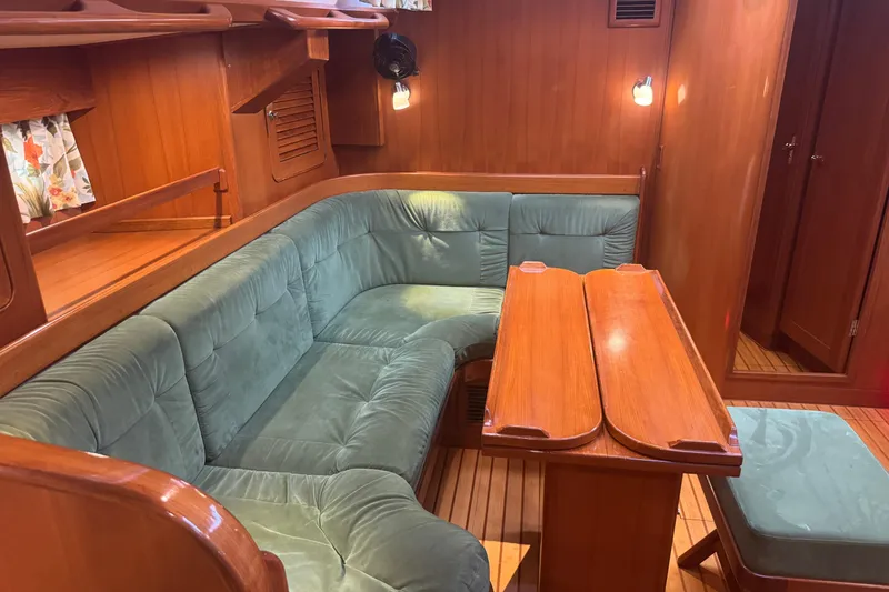 Slide: The Image of Cozy interior of 2007 Hylas H49 yacht with green upholstery and wooden table. - 15