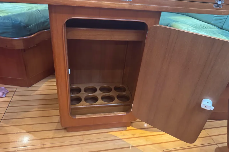Slide: The Image of Wooden cabinet with open door, showcasing bottle storage, on a 2007 Hylas H49 yacht. - 18