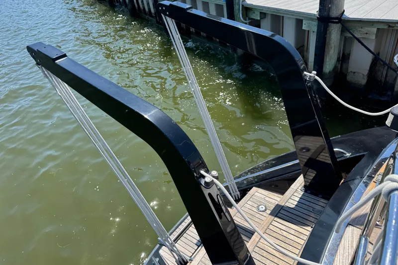 Slide: The Image of Sleek black davits on a 2007 Hylas H49 yacht, docked by the water. - 68