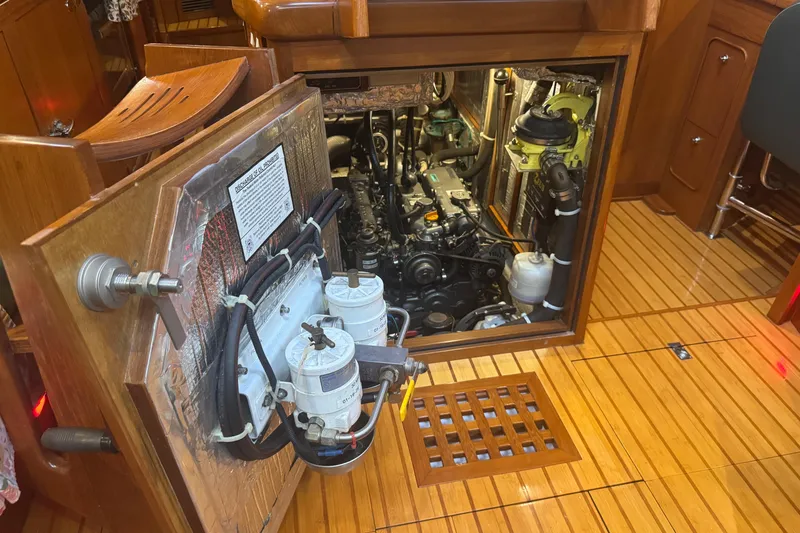 Slide: The Image of Engine room of a 2007 Hylas H49 yacht with visible components and wooden flooring. - 44