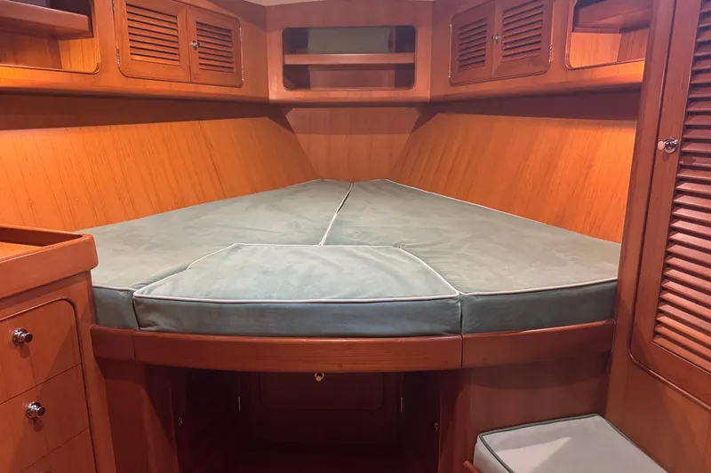 Slide: The Image of Cozy cabin interior of 2007 Hylas H49 yacht with wooden finish and cushioned bed. - 6