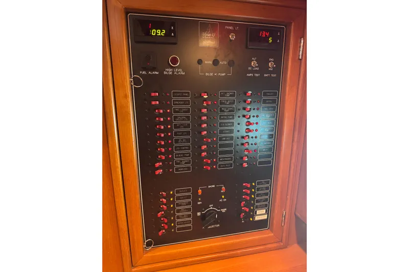 Slide: The Image of Electrical control panel on a 2007 Hylas H49 yacht, featuring various switches and indicators. - 24