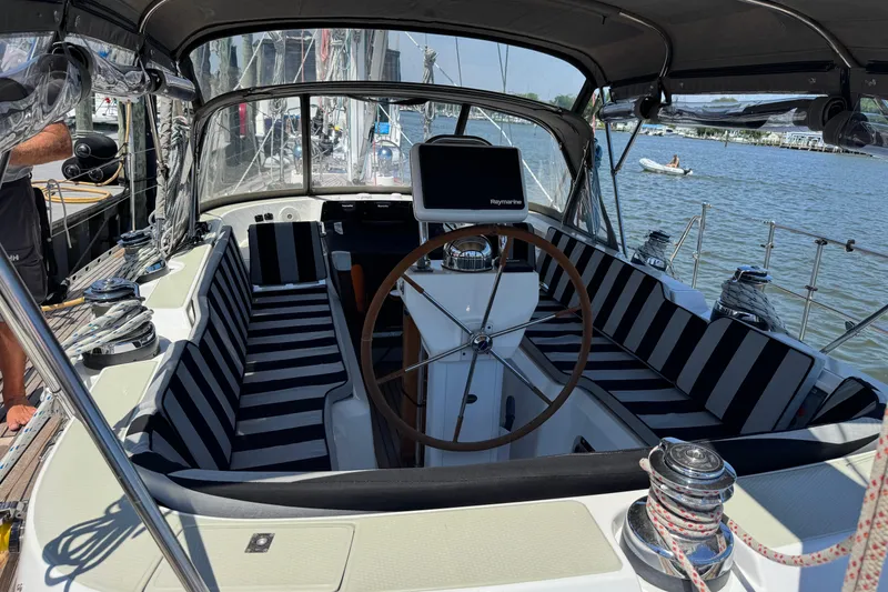 Slide: The Image of Cockpit of 2007 Hylas H49 yacht with striped seating and steering wheel. - 69