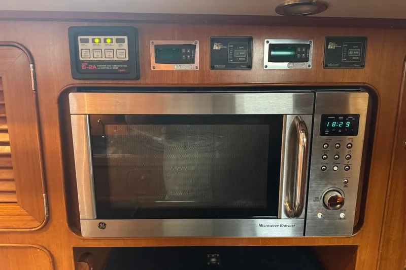 Slide: The Image of Built-in microwave and control panels on a 2007 Hylas H49 yacht interior. - 31