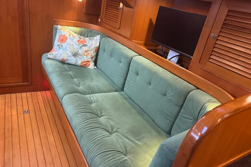Slide: The Image of Luxurious interior of 2007 Hylas H49 yacht with green sofa and floral pillow. - 20