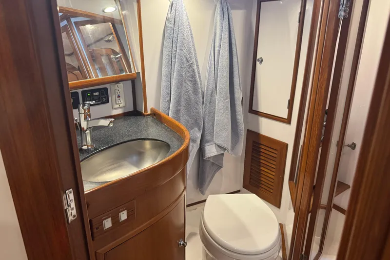 Slide: The Image of Luxurious 2007 Hylas H49 yacht bathroom with modern sink and wooden accents. - 41
