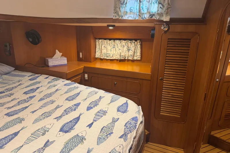 Slide: The Image of Cozy cabin interior of 2007 Hylas H49 yacht with fish-patterned bedding. - 40