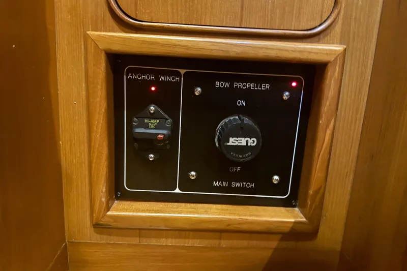 Slide: The Image of Control panel on a 2007 Hylas H49 yacht featuring anchor winch and bow propeller switches. - 54