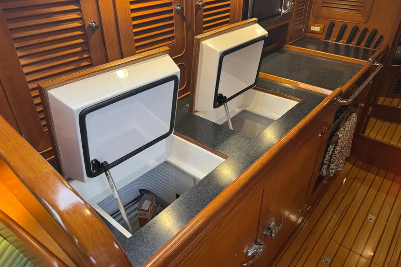 Slide: The Image of Interior of 2007 Hylas H49 yacht showing open galley storage compartments. - 33