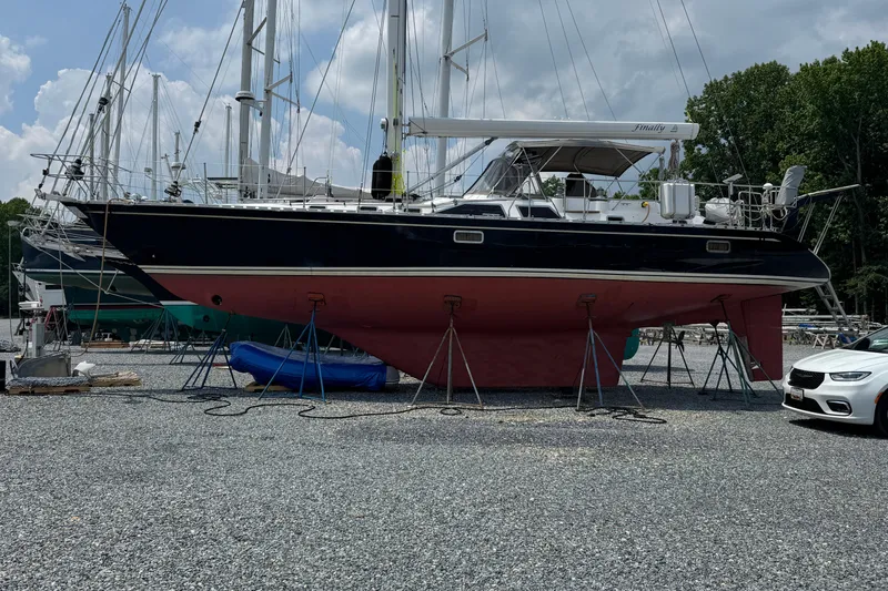 Slide: The Image of 2007 Hylas H49 sailboat on stands in a boatyard, clear sky background. - 55